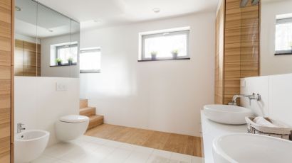New second-floor bathroom addition with toilet and expansive mirrors