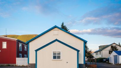 Modern white house with a front-facing garage-type accessory dwelling unit highlighted by blue trim