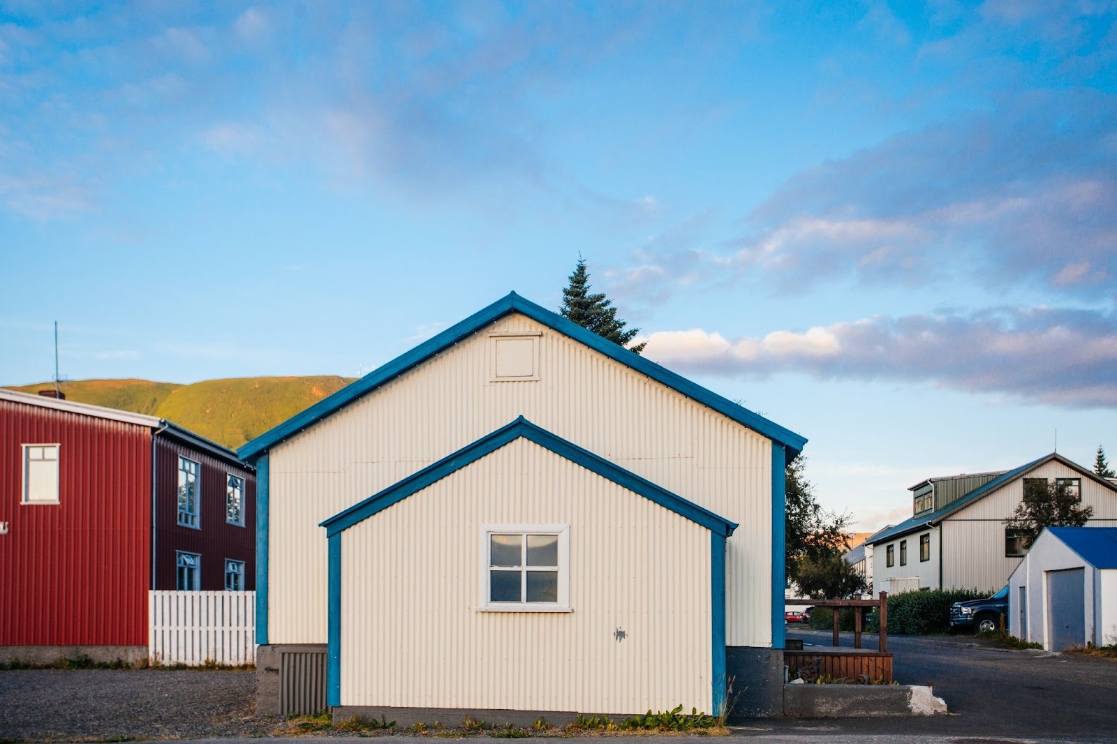 Modern white house with a front-facing garage-type accessory dwelling unit highlighted by blue trim