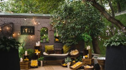 Lounge-style outdoor patio set for a ceremony with warm string lights and fresh lemon accents