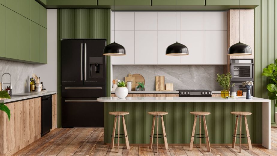 Stylish kitchen with green cabinets, a spacious island, and bar stools