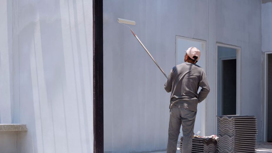 Professional painter using a roller to achieve even wall coverage