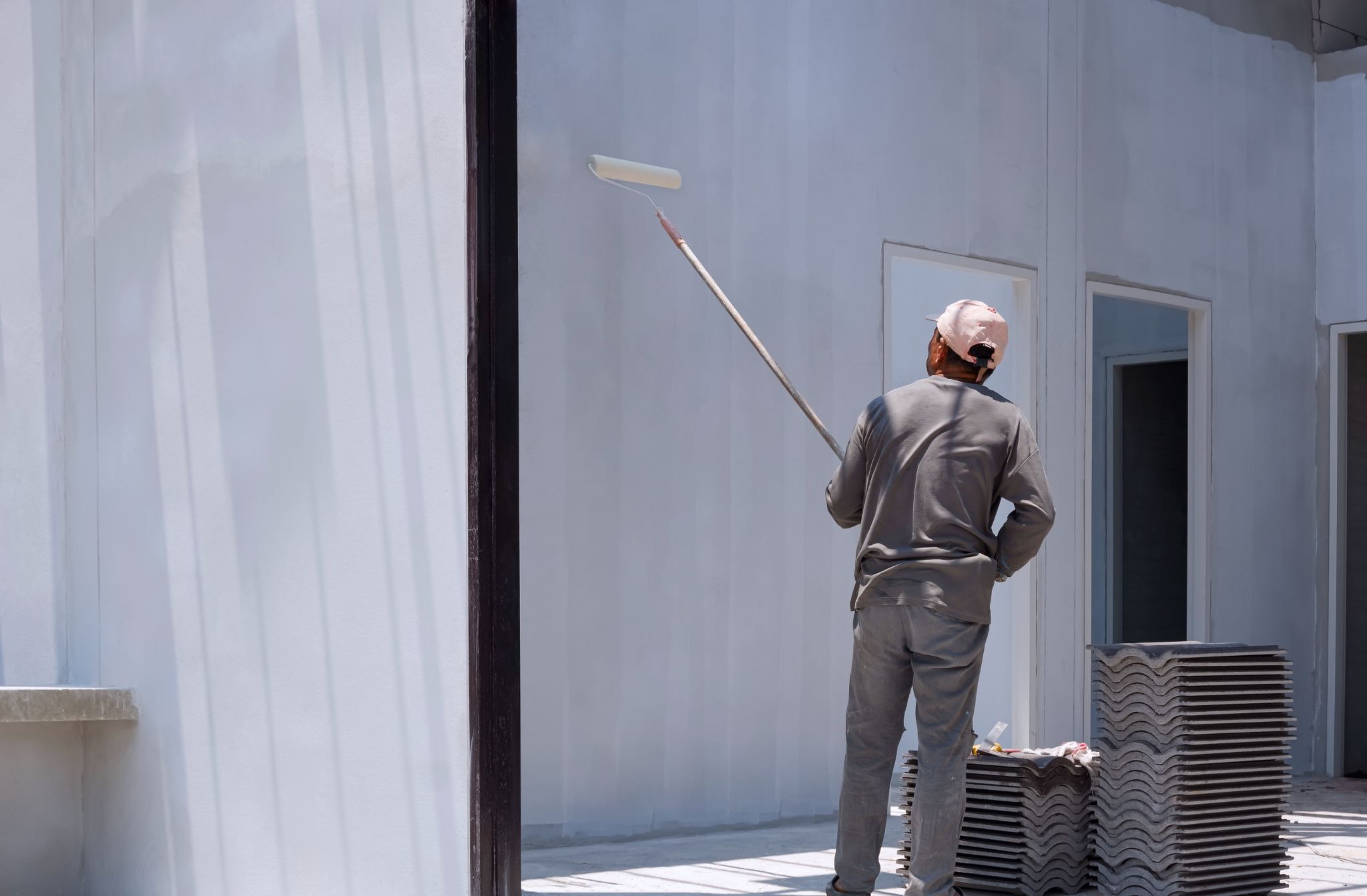 Professional painter using a roller to achieve even wall coverage