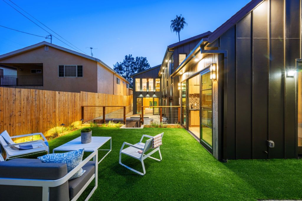 Modern backyard designed for an ADU with outdoor seating and landscaped green space